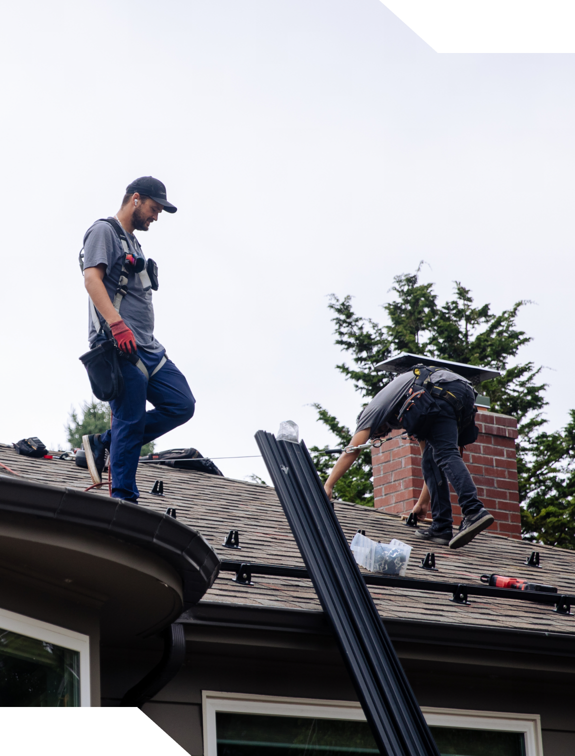 Construction workers installing roofing materials